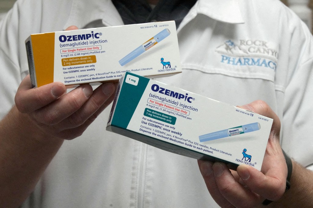 A pharmacist displays boxes of Ozempic