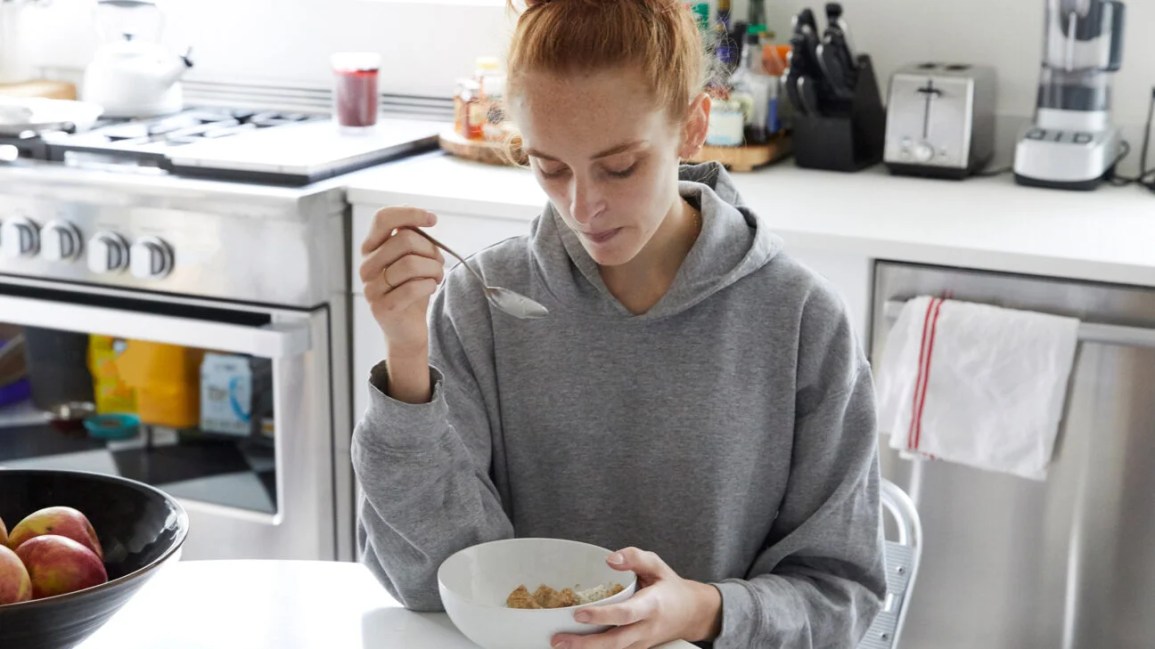 A woman eating cereal.